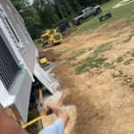 Manufactured Home in the process of installing the skirting